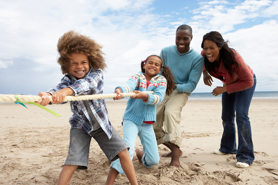 black family playing on beach