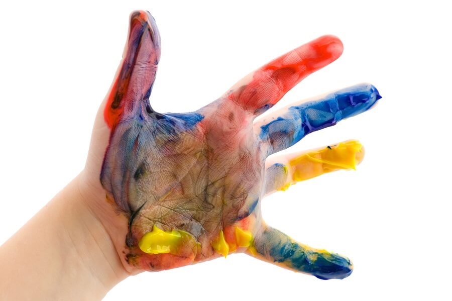Child's hand covered in paint