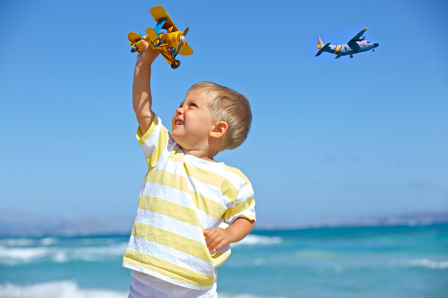boy playing with toy plane