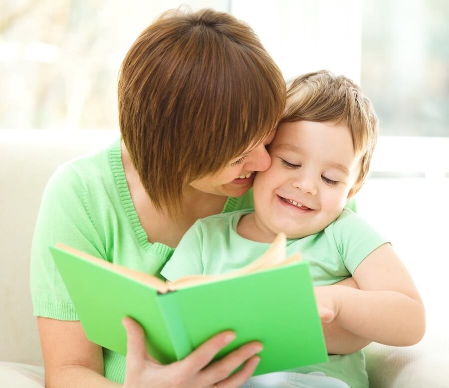 Mother reading book to her son