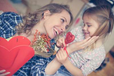 child giving her mother a sweet mother's day gift